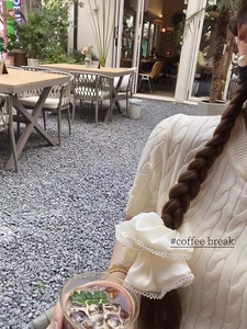 Elegant cream satin scrunchie with pearl trim shown on a braided ponytail