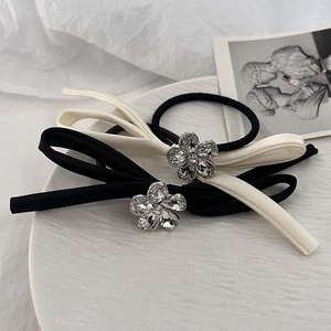 Elegant satin bow hair scrunchies with crystal flower accents in black and cream