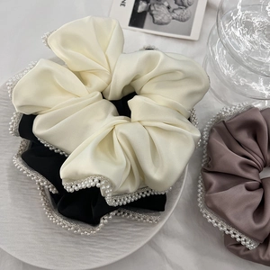 Elegant satin hair scrunchies with white faux pearls in cream, black, and brown colors