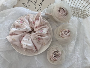 Detail of pink floral silk scrunchie and organza rose hair clips in French country style