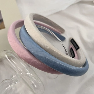 Three-piece set of thin macaron satin headbands in pink, blue, and white colors