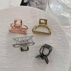 Set of four minimalist metal hair claws in rose gold, silver, and gold finishes