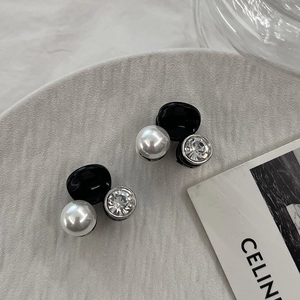Détail de mini pinces à cheveux avec perles noires, perle blanche et strass brillant