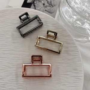 Three-piece set of minimalist alloy hair claw clips in black, gold, and rose gold colors