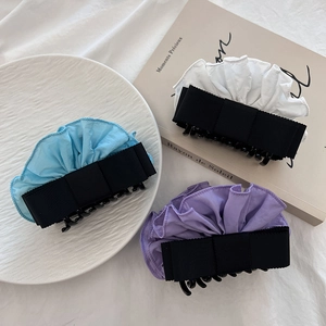 Detailed set of three bow hair claws in light blue, cream white and soft lavender purple