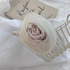 Macro shot of an elegant pink floral hair claw clip made of organza and cotton fabric