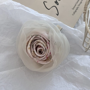 Detailed view of handmade pink fabric flower hair claw clip with sheer organza layers