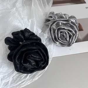 Elegant rose flower scrunchies in black and silver gray with shiny pleated fabric texture