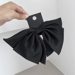 Elegant large black satin layered bow hair clip with spring fastener on brand card