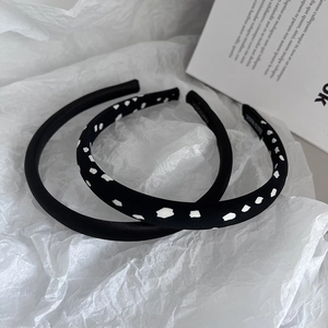 Detail view of handmade sponge headbands set in solid black and zebra dot patterns