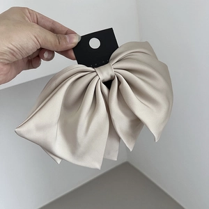 Elegant champagne satin oversized layered bow hair clip with a glossy finish for women