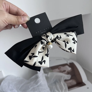 Elegant large black and white bow hair clip with pearl pendant and fabric ribbon texture