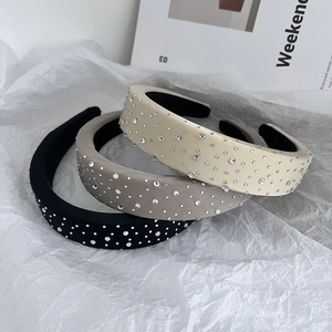 Detailed view of luxury sponge headbands in black, grey and beige with shiny rhinestones