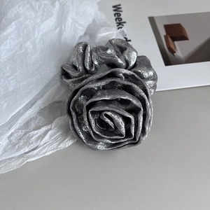 Detailed macro view of the elegant silver rose fabric scrunchie with metallic silk texture