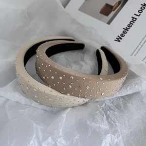 Detail of padded sponge headbands with sparkling rhinestones in beige and khaki shades