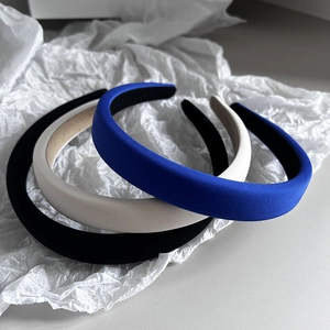 Three padded sponge headbands in black, cream and blue with glossy satin finish