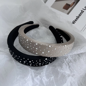 Detail view of French padded sponge headbands with scattered white rhinestones in two colors
