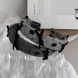 Detailed view of handmade textured fabric headbands with elegant velvet bows
