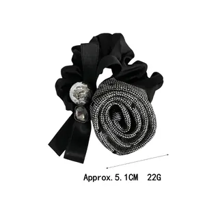Elegant black satin hair scrunchie with grey woven rose and silver charm ornaments