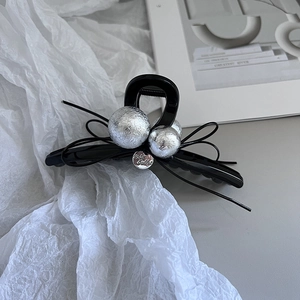 Elegant large black hair claw clip with silver matte beads and bow detail for thick hair