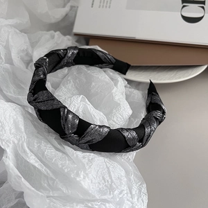 Detail of twisted black silk fabric and silver glitter fabric woven headband