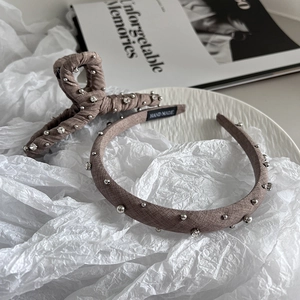 Detail of handmade fabric headband and hair claw clip with pearls and rhinestones