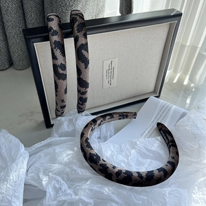 Winter wool leopard print headband with a handmade label and stylish retro french design