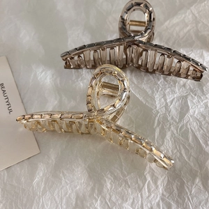 Elegant large crystal hair claw clips in brown and grey with geometric cut design