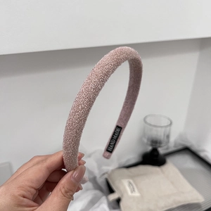 Close-up of handmade dusty pink fabric headband with soft textured sponge padding