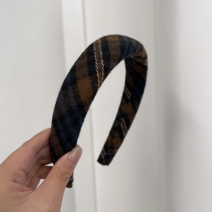 Close-up detail of British plaid padded headband with thick sponge and wool fabric