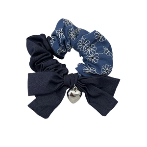 Denim floral scrunchie with daisy embroidery, blue bow, and heart pendant accessory