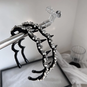 Punk style headband with pearls, crystals and sharp studs on a metal frame