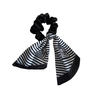 Elegant black silk scrunchie with a long black and white striped ribbon hair accessory