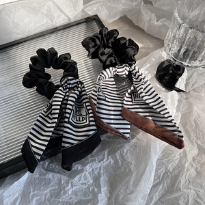 Elegant striped satin scrunchie with long ribbons for hair styling and daily wear