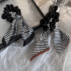Elegant black and white striped ribbon hair scrunchies with smooth satin finish texture