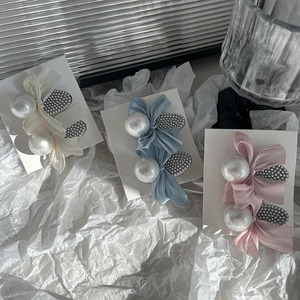 Elegant bow hair clips with pearls in white, blue, and pink for women and girls