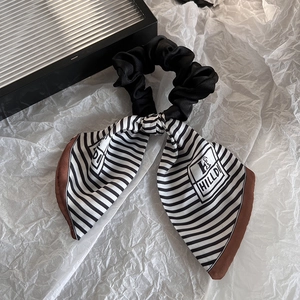 Elegant black and white striped bow hair tie with premium pleated fabric for daily wear