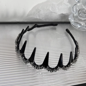 Detail of black shark tooth headband with shimmering crystal bead wrap and gothic style