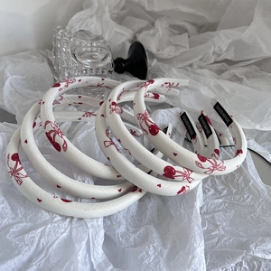 Padded cherry print headband set with cute red bows and handmade labels on white fabric