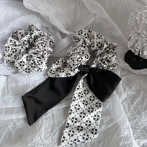 Classic black and white floral hair scrunchie set with elegant bow and silk texture