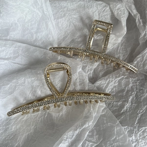 Elegant gold alloy hair claws with sparkling white rhinestones in two geometric shapes