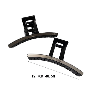 Pince à cheveux noire minimaliste avec lettrage smile argenté et détail métallique