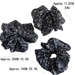 Three-piece set of black floral print scrunchies in 11.2cm, 16cm, and 20cm sizes