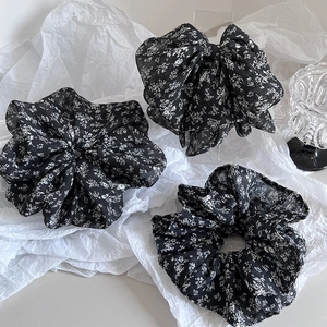 Elegant floral scrunchie set with black base and white flower pattern in chiffon fabric