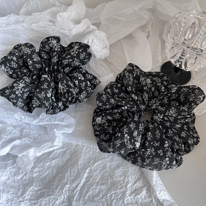 Minimalist floral print scrunchies in black and white fabric for versatile hair styling