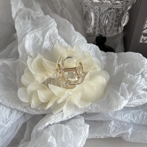 Close-up of large cream chiffon flower hair claw clip with transparent acrylic base
