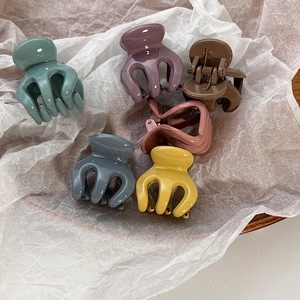 Set of 6 colorful matte octopus hair claw clips in Morandi tones on a white paper
