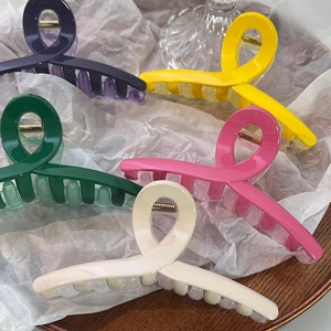 Détail de cinq grandes pinces à cheveux aux couleurs gelée comme violet jaune et rose