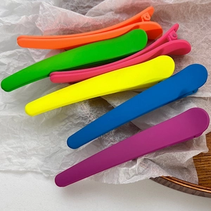 Close-up of colorful matte duckbill hair clips in assorted candy colors for women