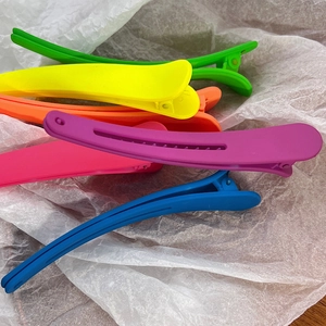 Macro detail of matte colorful hair clips in vibrant neon shades and frosted texture